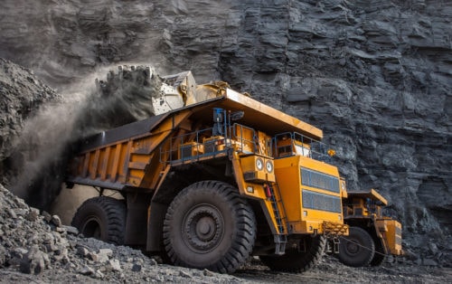 Yellow mining vehicles at quarry