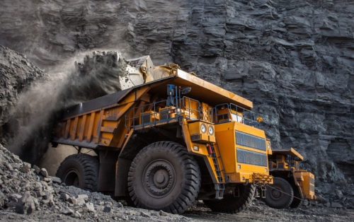 Yellow mining vehicles at quarry