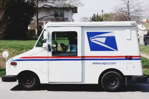 Mail carrier inside USPS mail truck