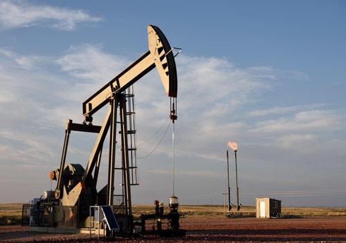 Oil or gas mining rig with partially cloudy sky behind